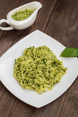 Pasta with pesto Brazilian. Wooden table. Top view
