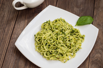 Pasta with pesto Brazilian. Wooden table. Top view