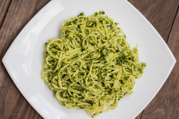 Pasta with pesto Brazilian. Wooden table. Top view