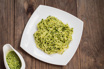 Pasta with pesto Brazilian. Wooden table. Top view