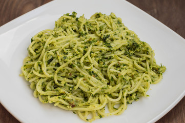 Pasta with pesto Brazilian. Wooden table. Top view