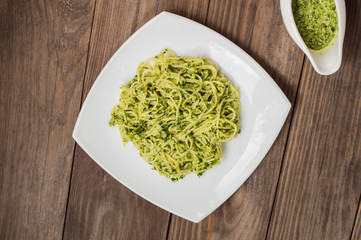Pasta with pesto Brazilian. Wooden table. Top view