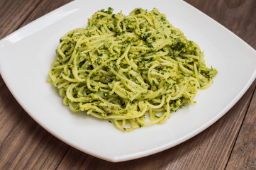 Pasta with pesto Brazilian. Wooden table. Top view
