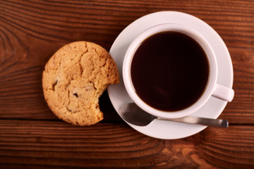Coffee and Homemade cookies with chocolate. Handmade Chocolate cookies and cup of espresso on wooden table. Pile of delicious chip cookies. Christmas cookies. Biscuits. Oat biscuits.