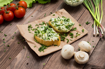 Sandwich of cheese with herbs. Wooden background. Top view