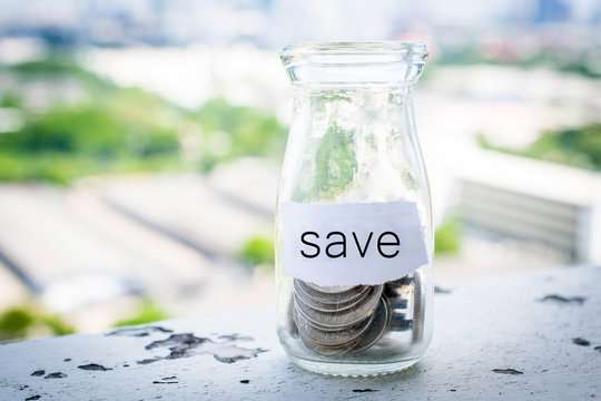  money into a glass jar for a savings