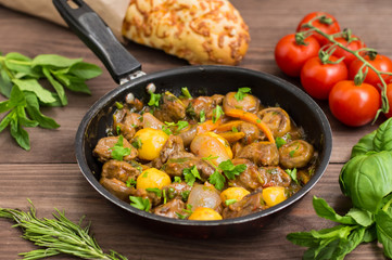 Meat in Burgundy in a frying pan. Old background. Top view