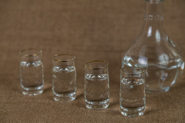 Stacks of vodka on a brown background