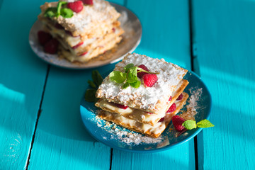 closeup of a flaky millefeuille pastry with raspberries
