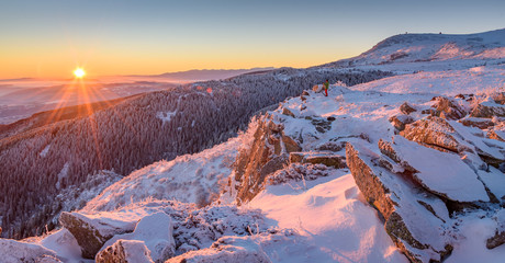 Beautiful frosty sunrise in the mountains - Vitosha, Bulgaria - the sun rising over the snowy...