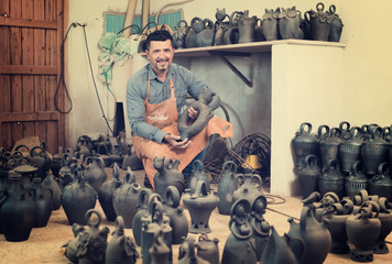 Male artisan with ceramic vases