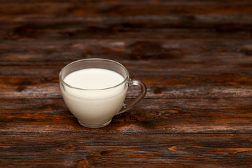Cup of milk on rustic wooden table