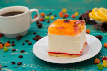 Cake with coffee and sweets  different fruits. Cute  a fabulous breakfast. Turquoise wooden background.