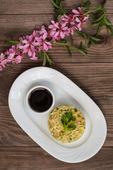 Fried rice with egg and greens. Chinese cuisine. Wooden background. Top view