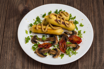 Zrazy Potato stuffed with meat  mushrooms and grilled tomatoes on a white plate. Wooden background. Top view. Close-up
