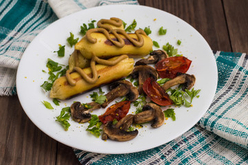 Zrazy Potato stuffed with meat  mushrooms and grilled tomatoes on a white plate. Wooden background. Top view. Close-up
