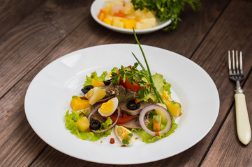 Salad with tongue on the wooden background