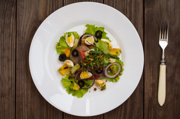 Salad with tongue on the wooden background. Top view. Close-up