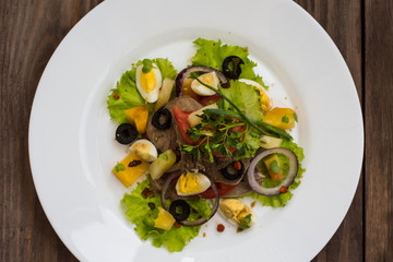 Salad with tongue on the wooden background. Top view. Close-up