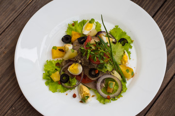 Salad with tongue on the wooden background. Top view. Close-up