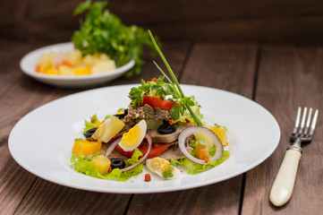 Salad with tongue on the wooden background