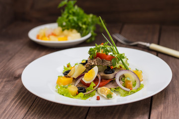 Salad with tongue on the wooden background