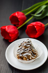 Cake with flowers. Romantic atmosphere. Wooden black table. Top view. Close-up