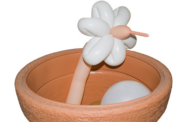 Flower balloon peeking out of the plastic pot