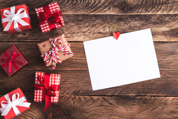 Fototapeta premium Greeting card or photo frame and valentines day felt toy heart over wooden background