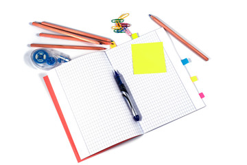 Top view of school workspace with notebook pen and stickers.