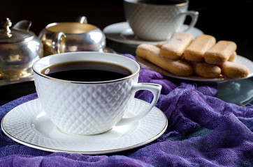 Tea in a white Cup. A dark photo.