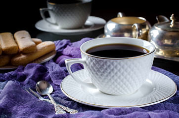 Tea in a white Cup. A dark photo.