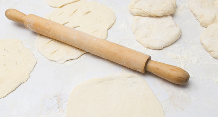 Fototapeta na wymiar rolling dough with a rolling pin