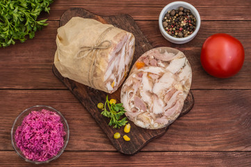 Aspic with meat and horseradish on a wooden table. Top view. Close-up