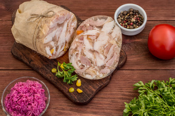 Aspic with meat and horseradish on a wooden table. Top view. Close-up