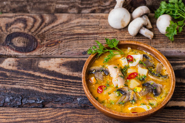 Delicious soup with smoked chicken, mushrooms,  eggs and cream. Old background. Top view