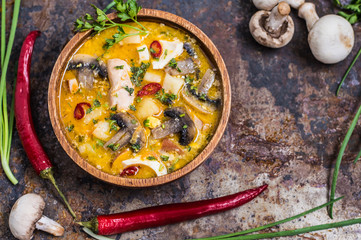 Delicious soup with smoked chicken, mushrooms,  eggs and cream. Old background. Top view