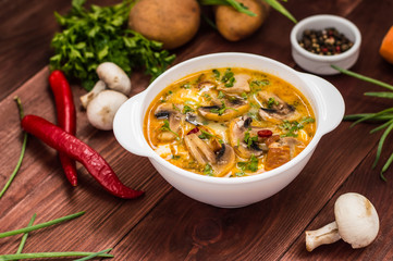 Delicious soup with smoked chicken, mushrooms,  eggs and cream. Wooden background