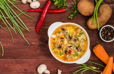Delicious soup with smoked chicken, mushrooms,  eggs and cream. Wooden background