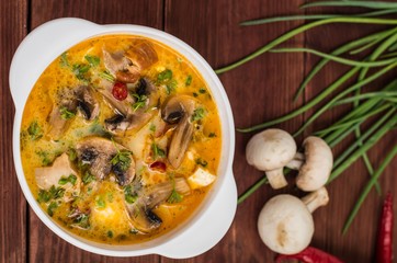 Delicious soup with smoked chicken, mushrooms,  eggs and cream. Wooden background