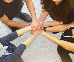 Group of people with hands together showing teamwork