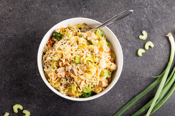 Chinese chicken lo mein with cabbage, carrots, celery, mushrooms, turnips, broccoli, and assorted vegetables top view