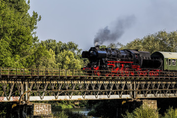 Fototapeta na wymiar steam train on a bridge