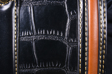 seams on leather hand bag