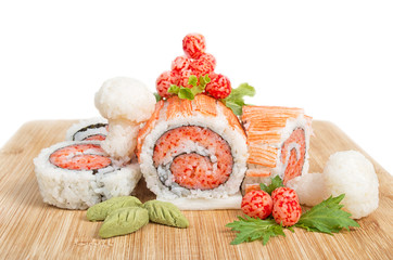 Christmas log sushi made with rice and seafood on wooden platter