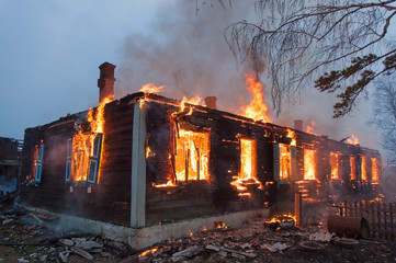Firefighters extinguish a house and building