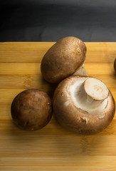 mushroom champignons on a wooden Board