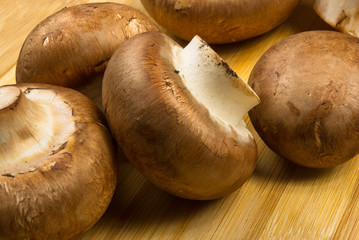 mushroom champignons on a wooden Board