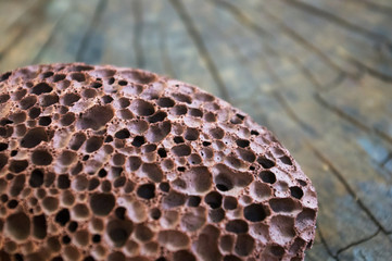 pumice stone with a cord on old wooden background