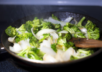 beef broccoli and onion stirfry steaming in pan